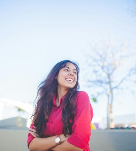 Female college student smiling outdoors on campus